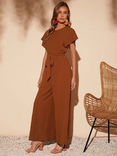 This elegant piece from our collection is a must-have for any wardrobe. Butterfly Sleeve Belted Wide Leg Jumpsuit is crafted from a lightweight fabric, the wide-leg silhouette is enhanced by a belted waistline and regular fit. Featuring a round neckline, short butterfly sleeves, and a long length, this piece is sure to bring a touch of sophistication to any look. It's perfect for any formal occasion or just to add some flair to your everyday style coming in black and brown colors. Features: Styl International Fashion Designers, Comfy Jumpsuits, Belt Length, Stil Elegant, Butterfly Sleeves, Formal Attire, Sleeveless Jumpsuits, Wide Leg Jumpsuit, Black Jumpsuit