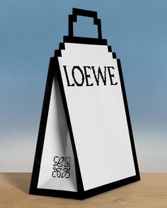 a piece of paper with the word loewe written on it sitting in front of a blue background