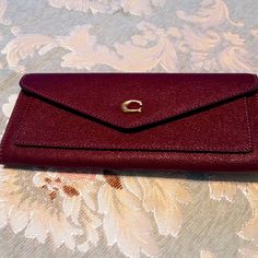 Coach Wyn Cross Grain Textured Leather Wallet. New With Tags. Color Is Deep Berry Multi. Signature Polished Hardware. Approximate Size Is 7 3/4" Length, 3 1/2" Height And 1/2" Depth. Concealed Snap Flap Closure. Exterior Slip Pocket. Interior Bill Compartment. Eight Interior Card Slots. Coach Wallets With Removable Pouch For Formal Use, Formal Coach Wallet With Removable Pouch, Coach Elegant Wallet With Cell Phone Pocket, Coach Clutch With Card Slots For Everyday, Everyday Coach Wallet With Removable Pouch, Elegant Coach Clutch With Card Slots, Chic Coach Wallets For Travel, Classic Coach Clutch With Card Slots, Coach Clutch Wallets For Everyday Use