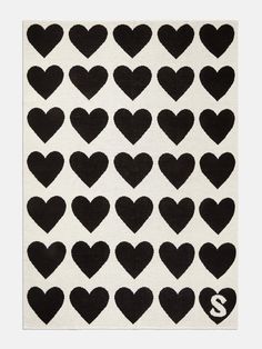 a black and white heart rug with the letter s in it's center, surrounded by smaller hearts