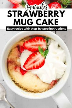 strawberry mug cake in a white cup with whipped cream and strawberries on the top