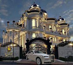 a car is parked in front of a large white building with ornate designs on it