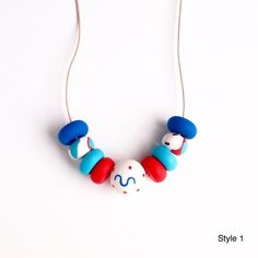 Red Dots - Handmade Clay Necklaces - Mixed Colors - Wearable Art - Jewelry - Unique Design - With Leather Cord Artistic White Round Necklace, Playful Handmade Blue Beaded Necklaces, Handmade Red Necklace For Everyday, Everyday Handmade Red Necklaces, Handmade Red Craft Supplies, Handmade Artsy Red Jewelry, Artsy Handmade Red Jewelry, Playful Red Adjustable Necklace, Handmade Everyday Beaded Necklaces