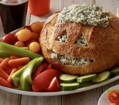 a white plate topped with bread and veggies on top of a wooden table