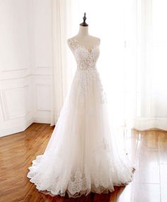 a wedding dress on display in front of a window