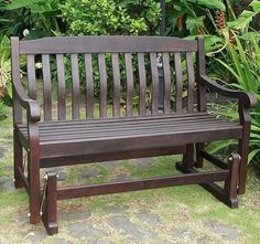 a wooden bench sitting in the middle of a garden