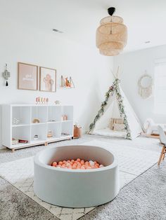 a room with a teepee tent and toys in it