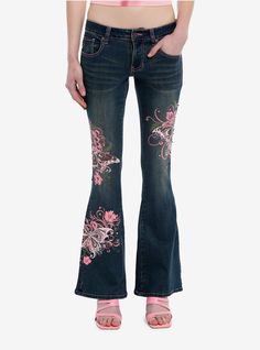 Live out your Y2K pop princess dreams in these dark indigo jeans! They have a low rise flare silhouette and feature pink butterfly  swirl and flower designs on the legs  plus rhinestone detailing. Comes with 5-pocket styling.69% cotton; 29% polyester; 2% spandexWash cold; dry flatStretchy materialRise: 10''Inseam: 29''ImportedListed in junior sizesModel is 5'10''Model wears size 3 Embroidered Low Rise Jeans, Pink 2000s Outfit, Jeans Back Pocket Design, Depop Tips, Mermaid Jeans, Pink Flare Jeans, Jeans With Designs, Rhinestone Clothes, Y2k Pink Outfit