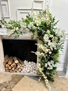 a fireplace decorated with flowers and rocks