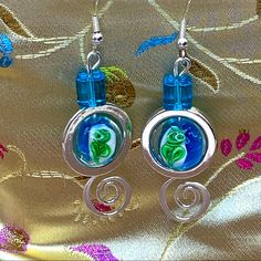 the earrings are made with glass and silver wire