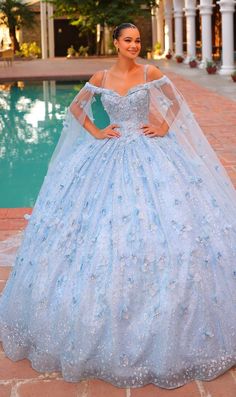 Long pastel off the shoulder quinceanera ball gown with 3D floral details and sheer cape sleeves. Sweet 15 Dresses Quinceanera Light Blue, Baby Blue Quince Dresses, Sweet 15 Dresses Quinceanera, Baby Blue Quince, Baby Blue Quinceanera Dresses, Blue Quince Dress, Light Blue Quinceanera Dresses, Baby Blue Quinceanera, Quince Themes