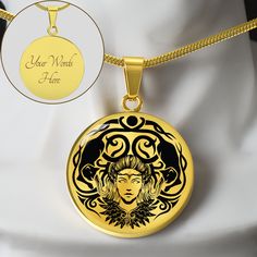 a woman's face is shown in the center of a gold necklace with an inscription on it