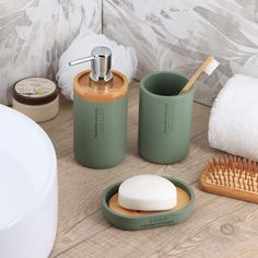 bathroom accessories including soap dispenser, brush and toothbrush on wooden table