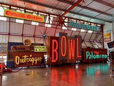 the inside of a building with neon signs