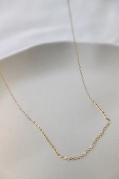 Our staple gold filled cable chain is the perfect piece for a simple yet classic look. Use for layering or choose from our charm collection to make your own unique piece. Available in multiple lengths for your desired fit. Details: - 14kt gold filled - simple cable chain - 16", 18", or 20" length SKU: CN1502 Materials+Care Dainty Charm Necklaces With Cable Chain For Anniversary, Minimalist Name Necklace With Cable Chain For Gift, Minimalist Name Necklace With Cable Chain As Gift, Gold Pendant Birthstone Necklace With Delicate Chain, Gold Sterling Silver Birthstone Necklace With Adjustable Chain, Gold Birthstone Necklace With Delicate Chain And Round Pendant, Gold Heart Pendant Necklace For May Birthstone, Personalized Yellow Gold Cable Chain Jewelry, Minimalist 14k Gold Name Necklace With Cable Chain