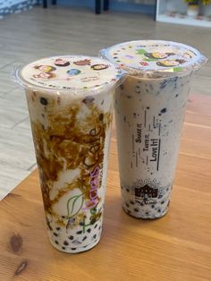 two drinks sitting on top of a wooden table