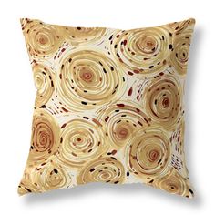 a yellow and brown pillow with circles on it