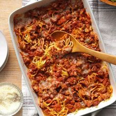 a casserole dish filled with spaghetti and meat