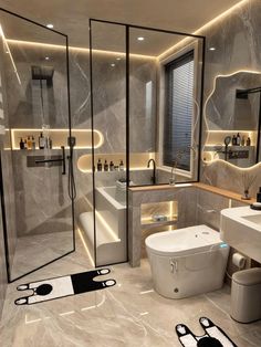 a modern bathroom with grey marble walls and flooring, lighted by recessed lighting