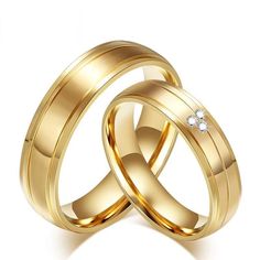 two gold wedding rings with diamonds on each one, set against a white background and the other