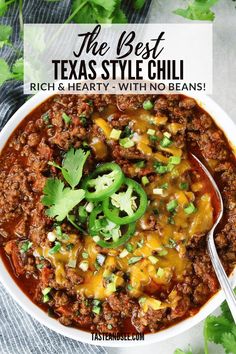 a white bowl filled with chili and topped with cilantro