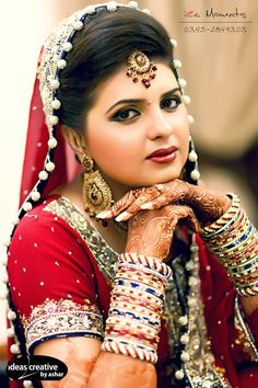 a woman in red and gold dress with jewelry on her head, posing for the camera