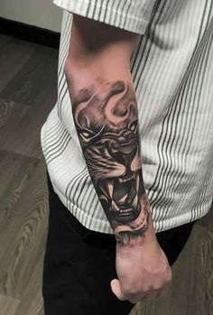 a man's arm with a tiger tattoo on the left side of his arm