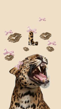 a leopard with its mouth open and some pink bows on it's head is shown