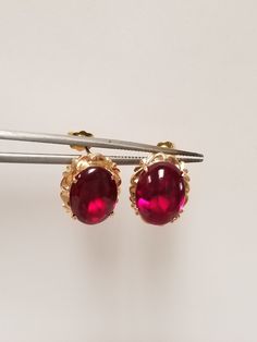 "Thanks for shopping our vintage estate store. We tend to sell well below wholesale and truly hope you enjoy all of our items. Many of the items are one of a kind, so please enjoy scrolling through the pictures and hopefully something will catch your eye. Brown spots are from camera or reflections. Nice estate 18k yellow gold natural 6ct ruby or spinel stud earrings. Assuming these are spinel, testing ruby, but a lot of these types of gems will test natural and may even be created. Size: 1/2\" by 3/8\" Ruby: 11mm by 8mm Weight: 3.83 grams Gems: 3ct each ruby Marked 18k and these are stunning. These are antique earrings." Classic Cabochon Clip-on Earrings For Formal Occasions, Classic Gemstone Earrings For Formal Occasions, Classic Formal Gemstone Earrings, Luxury Oval Clip-on Earrings For Anniversary, Formal Cabochon Fine Jewelry Earrings, Formal Cabochon Earrings In Fine Jewelry Style, Formal Clip-on Earrings With Oval Cabochon, Yellow Gold Oval Clip-on Earrings With Polished Finish, Elegant Oval Clip-on Earrings For Anniversary