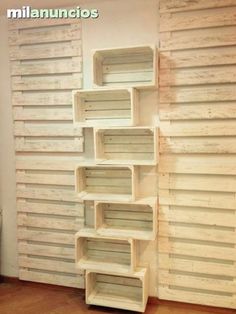 the shelves are made out of pallets and have wooden slats on each side