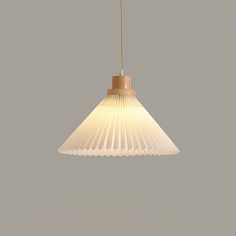 a white light hanging from a ceiling with a wooden pole and wire attached to it