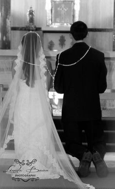 the bride and groom are standing at the alter