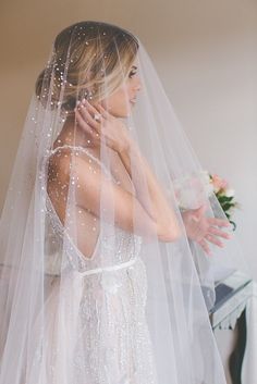 a woman wearing a wedding veil on her cell phone with the text, this veil