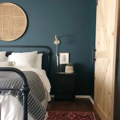 a bed room with a neatly made bed and a wooden door