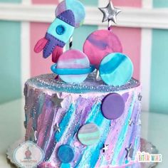 a colorful cake decorated with space and stars