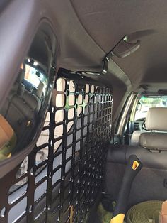 the interior of a vehicle with various items in it's cargo compartment and back door