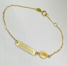 Baby ID with Miraculous Bracelet 14K yellow gold measuring 6'' inches long and ID plate measures 20mm. **Please note: When choosing what to engrave please make sure you write what you want engraved in boxes provided and choose font Block or Script if you have any questions please text or email us at: 786-589-3076 or bosjewelers@gmail.com** Personalized Yellow Gold Rectangular Name Bracelet, Personalized Rectangular Yellow Gold Name Bracelet, Engraved Yellow Gold Name Bracelet For Personalized Gift, 14k Gold Name Bracelet With Engraving Option, Yellow Gold Nameplate Bracelet With Engraving Option, 14k Gold Engraved Nameplate Bracelet, Engravable Nameplate Bracelet In Yellow Gold, Elegant Gold Name Bracelet With Engraved Text, Gold Rectangular Name Bracelets