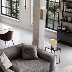 a living room filled with furniture and windows