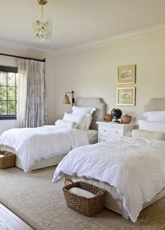 two beds in a bedroom with white linens