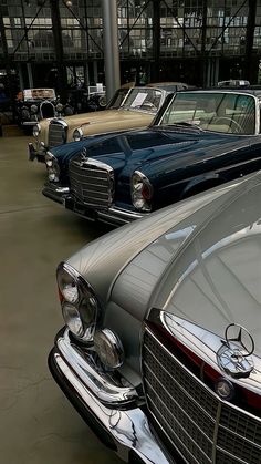 several old mercedess are lined up in a row