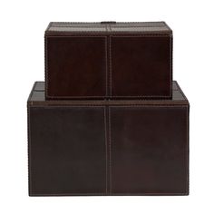 two brown leather boxes sitting on top of each other