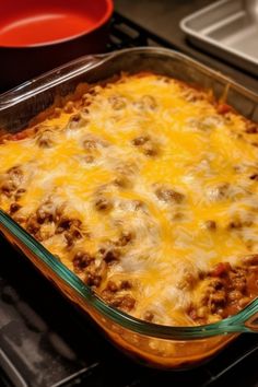 a casserole dish with meat and cheese in it on top of the stove