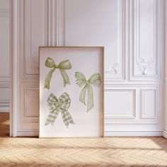 a white room with a green bow on the wall next to a framed photograph in front of it