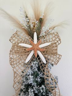 a starfish decoration on top of a christmas tree