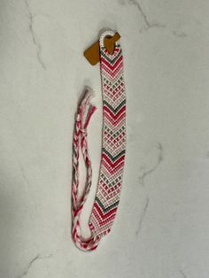 This bracelet has a Polka Dot Chevron pattern. It is about 11 inches long. Handmade Casual Band Bracelet, Adjustable Band Bracelet As Fashion Accessory, Adjustable White Band Bracelet, White Adjustable Bracelet Wristlet, Adjustable White Wristlet Bracelet, Adjustable Red Band Bracelets, Adjustable Pink Band Bracelet, Black And White Chevron Bracelet, Dotted Border Chevron Bracelet