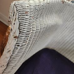 the back end of a white wicker chair