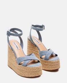 Elevate your style with LULAH   sandals . Featuring a raffia sole and a comfortable   wedge , these sandals are perfect for any summer adventure. The crisscross front strap and ankle strap add a touch of elegance, while the platform provides extra support.  5 inch heel height 2 inch platform Textile upper material Synthetic lining Synthetic sock Synthetic sole Imported Denim Espadrilles, Steve Madden Store, Comfortable Wedges, Apparel Merchandising, The Platform, Summer Adventures, 5 Inch Heels, Denim Fabric, Women's Sandals