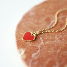 "Beautiful and lovely red heart charm necklace. Made of red enamel gold heart charm with skinny gold plated brass chain. Simple and warm. Great for gift, everyday or special occasion. Please choose chain color and length. Your item will ship in a gift box. Please feel free to contact me if you have any questions. ♥ Chain length available 14\" - 20\" ♥ Red heart 3/8\" ♥ Gold plated over brass/enamel ♥ See more Rudiana Accessories Rudiana.etsy.com" Red Enamel Charm Necklaces For Gifts, Enamel Heart Charm Necklace For Valentine's Day, Gold Enamel Heart Necklace For Valentine's Day, Valentine's Day Gold Enamel Heart Necklace, Valentine's Day Gift Enamel Charm Necklaces, Valentine's Day Gift Enamel Charm Necklace, Enamel Heart Pendant Necklace For Gift, Red Enamel Heart Pendant Necklace, Valentine's Day Charm Necklace With Delicate Chain