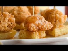 small appetizers with toothpicks and sauce on them sitting on a plate