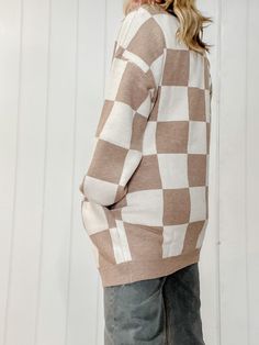 Introducing our Checker Graphic Sweater Cardigan, a versatile and stylish addition to your wardrobe. This cardigan seamlessly combines comfort and fashion with its soft, knit fabric and eye-catching checker graphic design. The classic cardigan silhouette makes it easy to layer over your favorite outfits, while the bold checker pattern adds a trendy and modern touch. Cozy Checkered Cardigan Regular Fit Pockets Open Cardigan Long Sleeve 68% Rayon, 32% Nylon Machine wash cold, gentle cycle, tumble Casual Plaid Sweater For Layering, Cozy Plaid Sweater For Spring, Plaid Sweater For Fall, Trendy Argyle Pattern Tops For Fall, Casual Argyle Pattern Top For Fall, Oversized Plaid Casual Cardigan, Oversized Casual Plaid Cardigan, Casual Oversized Plaid Cardigan, Plaid Cotton Sweater For Fall